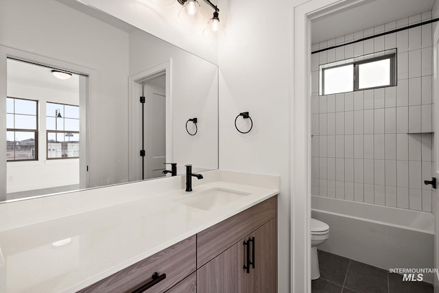 bathroom with tile patterned flooring, shower / bathing tub combination, toilet, and vanity