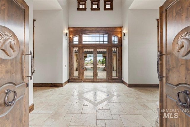7600 W Ledgerwood Ln, Meridian, ID 83646 - entrance foyer with baseboards, stone tile flooring, and a high ceiling