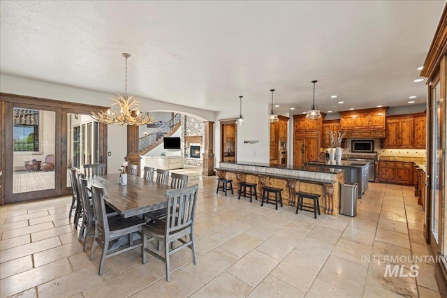 7600 W Ledgerwood Ln, Meridian, ID 83646 - dining space with recessed lighting, arched walkways, and a notable chandelier