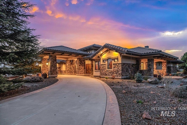 7600 W Ledgerwood Ln, Meridian, ID 83646 - prairie-style home featuring stucco siding, a chimney, a tiled roof, and stone siding