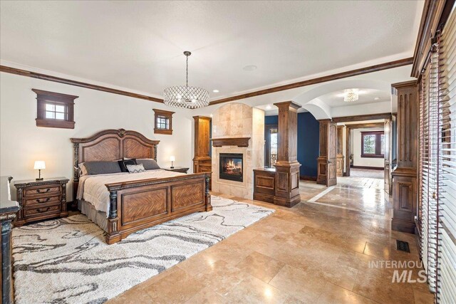 7600 W Ledgerwood Ln, Meridian, ID 83646 - bedroom featuring a fireplace, crown molding, visible vents, ornate columns, and arched walkways