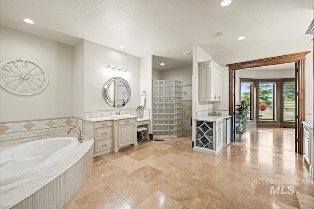 7600 W Ledgerwood Ln, Meridian, ID 83646 - full bathroom featuring recessed lighting, tiled shower, a bath, vanity, and a textured ceiling