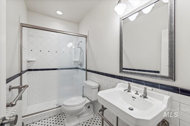 7600 W Ledgerwood Ln, Meridian, ID 83646 - full bathroom with toilet, a shower stall, a wainscoted wall, and a sink