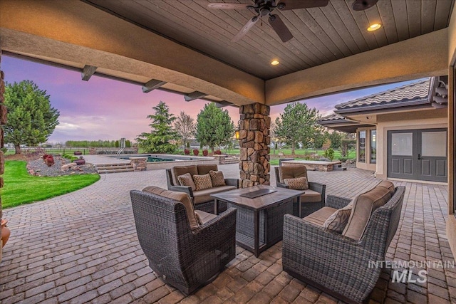 7600 W Ledgerwood Ln, Meridian, ID 83646 - patio terrace at dusk with an outdoor pool, a ceiling fan, an outdoor hot tub, and an outdoor living space