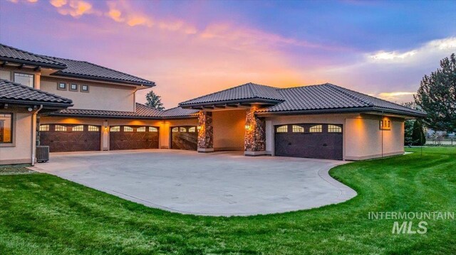 7600 W Ledgerwood Ln, Meridian, ID 83646 - view of front of property with stucco siding, a tiled roof, a garage, a front yard, and concrete driveway