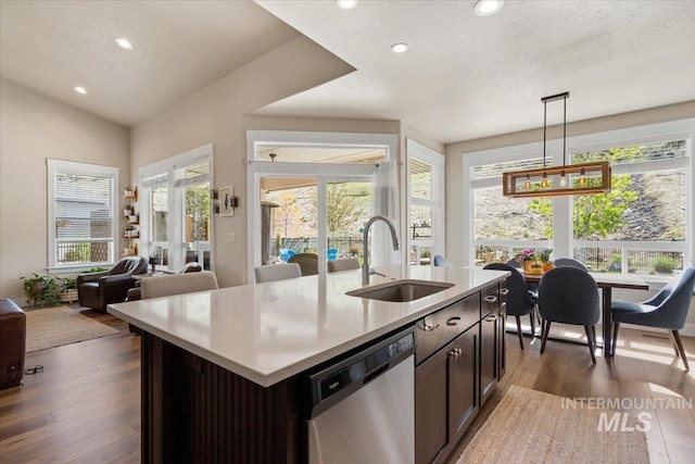 kitchen with light countertops, recessed lighting, a sink, and dishwasher