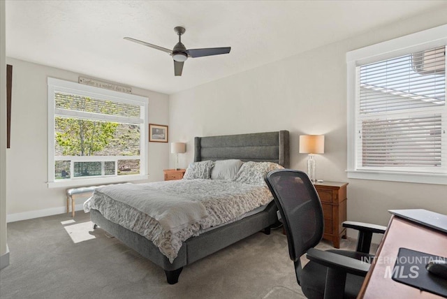 carpeted bedroom featuring baseboards and a ceiling fan