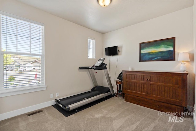 workout area featuring baseboards, carpet flooring, and visible vents