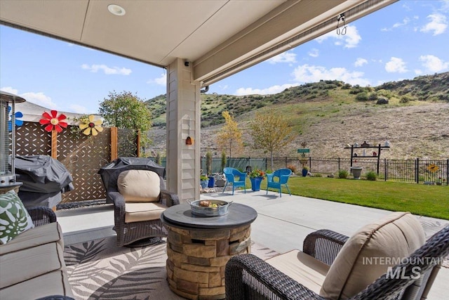 view of patio featuring a fenced backyard and a mountain view