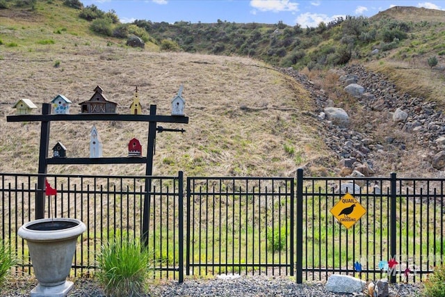 view of yard featuring fence and a mountain view