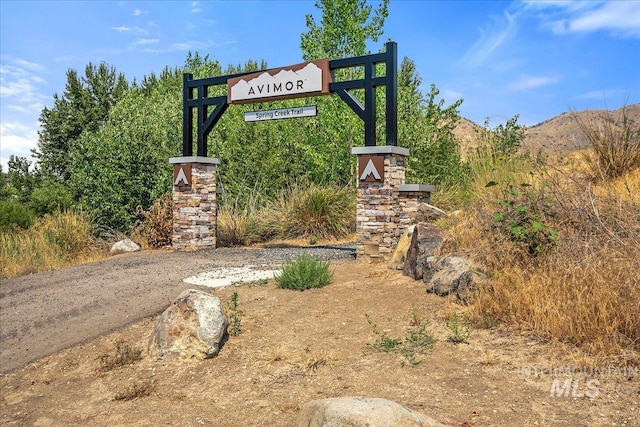 community sign with a mountain view