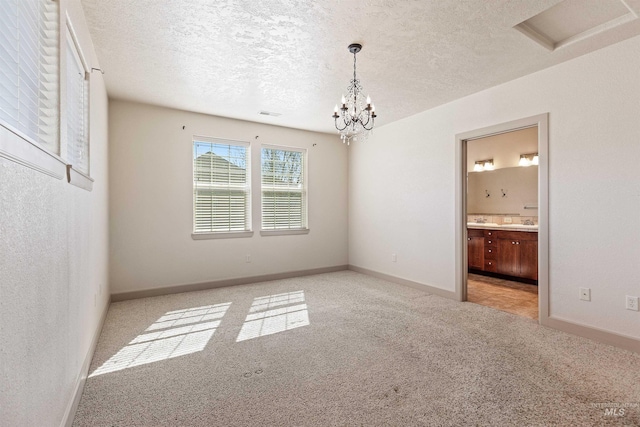 1148 E Winding Creek Dr, Eagle, ID 83616 - spare room with baseboards, an inviting chandelier, a textured ceiling, and carpet flooring
