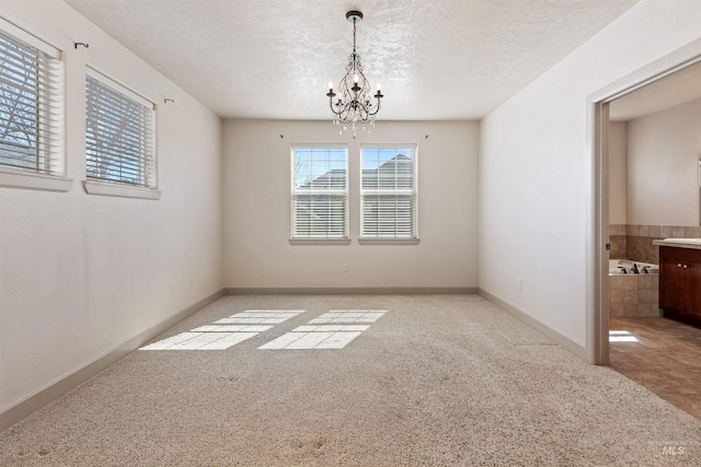 1148 E Winding Creek Dr, Eagle, ID 83616 - unfurnished room featuring a chandelier, baseboards, a textured ceiling, and carpet flooring