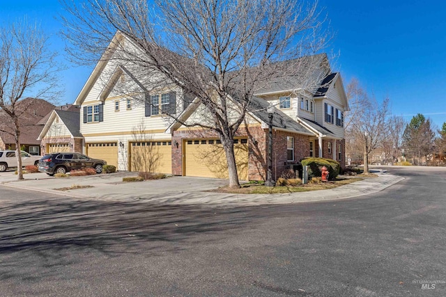 1148 E Winding Creek Dr, Eagle, ID 83616 - exterior space with driveway, a garage, and brick siding