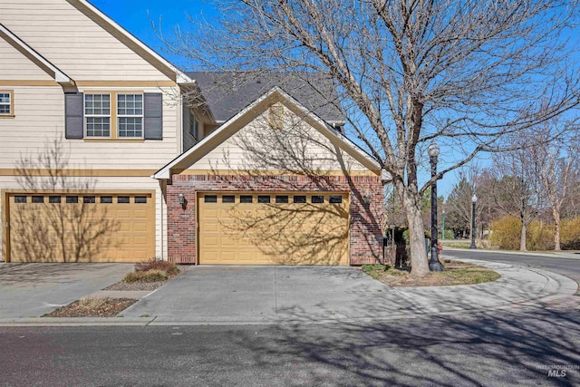 1148 E Winding Creek Dr, Eagle, ID 83616 - view of front facade with concrete driveway and brick siding