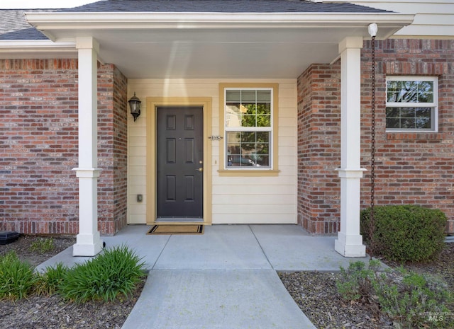 1148 E Winding Creek Dr, Eagle, ID 83616 - entrance to property with roof with shingles, covered porch, and brick siding