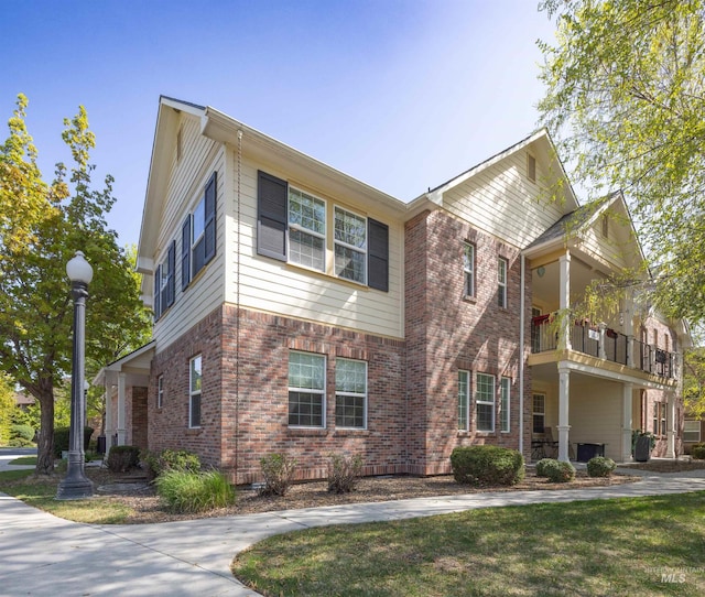1148 E Winding Creek Dr, Eagle, ID 83616 - view of front of house with brick siding and a balcony