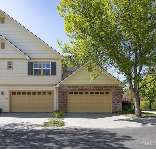 1148 E Winding Creek Dr, Eagle, ID 83616 - view of front of home with driveway and brick siding
