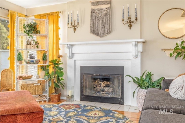 sitting room with a fireplace with flush hearth