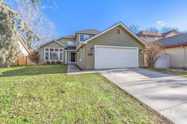 view of front of house featuring an attached garage, driveway, a front yard, and fence