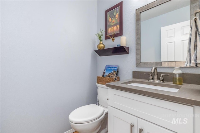 bathroom with toilet and vanity