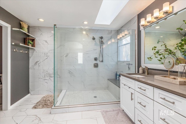 full bathroom with marble finish floor, a skylight, vanity, and a walk in shower