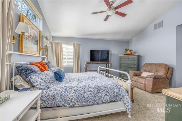 bedroom with lofted ceiling, a ceiling fan, visible vents, and carpet floors