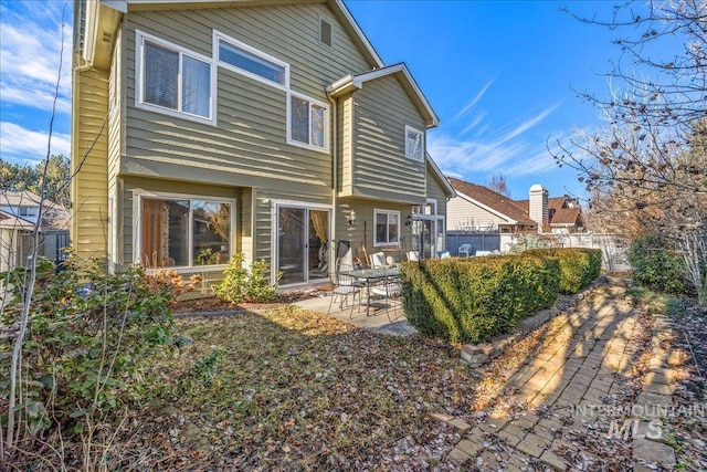 rear view of house with fence private yard and a patio