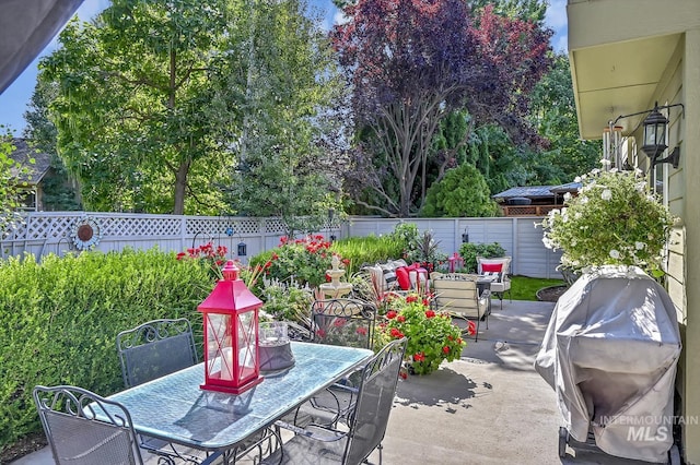 view of patio / terrace featuring outdoor dining area, area for grilling, and a fenced backyard