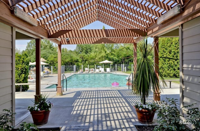 view of swimming pool with a patio area, a fenced in pool, fence, and a pergola