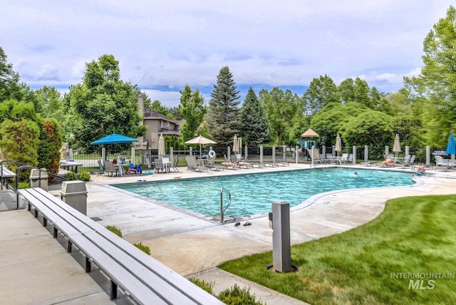 community pool featuring a patio area and fence