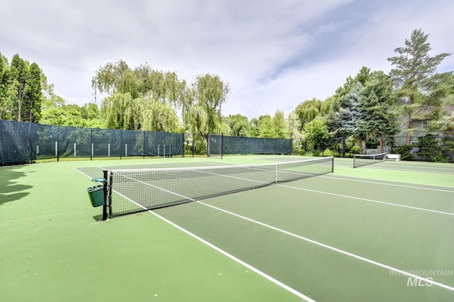 view of tennis court with fence