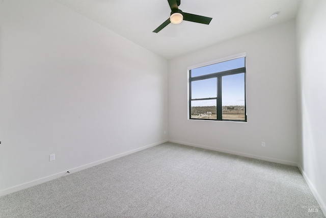 empty room with baseboards, light carpet, and ceiling fan