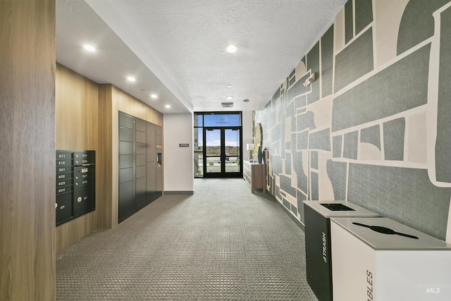 hallway with expansive windows, carpet, mail area, recessed lighting, and a textured ceiling