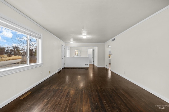 unfurnished living room featuring crown molding and dark wood-type flooring