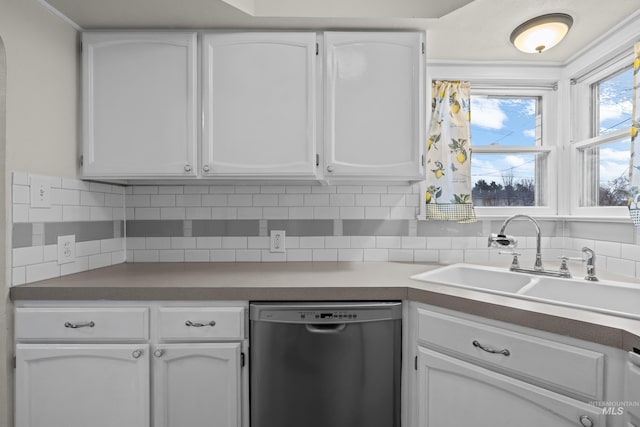 kitchen with stainless steel dishwasher, decorative backsplash, white cabinetry, and sink