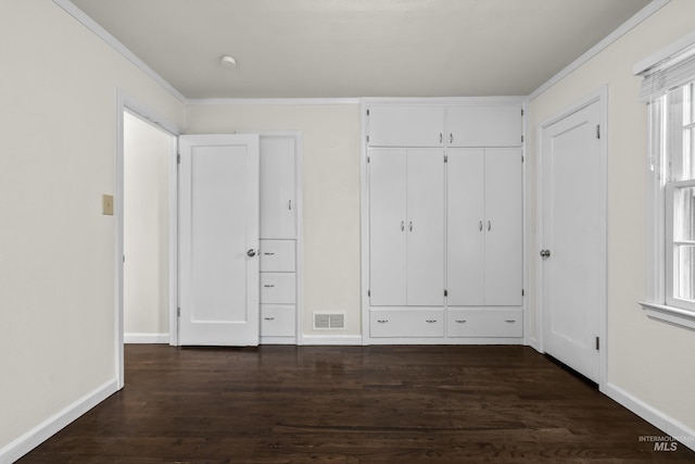 unfurnished bedroom featuring crown molding and dark wood-type flooring