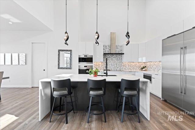 3492 E Heartleaf Dr, Boise, ID 83716 - kitchen featuring stainless steel appliances, extractor fan, white cabinets, light countertops, and modern cabinets