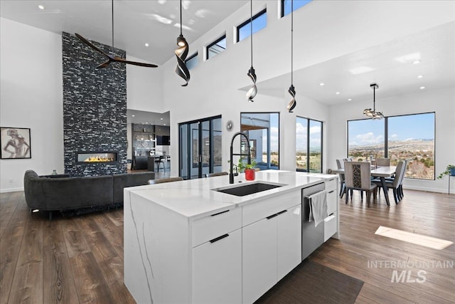 3492 E Heartleaf Dr, Boise, ID 83716 - kitchen with a sink, stainless steel dishwasher, open floor plan, and dark wood-style flooring