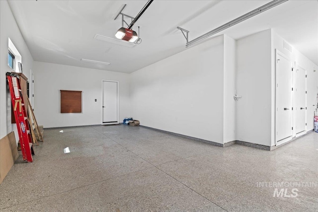 3492 E Heartleaf Dr, Boise, ID 83716 - garage featuring a garage door opener, visible vents, and baseboards