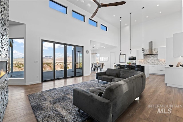 3492 E Heartleaf Dr, Boise, ID 83716 - living area with baseboards, light wood finished floors, recessed lighting, a fireplace, and ceiling fan