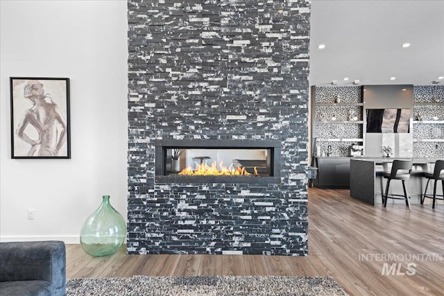 3492 E Heartleaf Dr, Boise, ID 83716 - living room featuring recessed lighting, a multi sided fireplace, and wood finished floors
