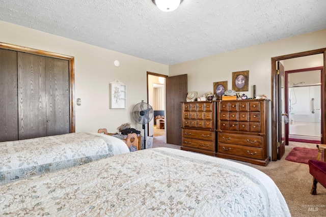 carpeted bedroom featuring a textured ceiling and a closet