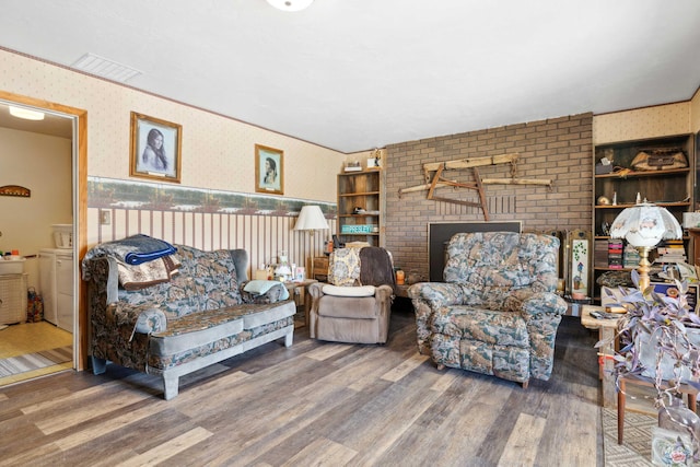 living room featuring washer and dryer, hardwood / wood-style floors, and built in features