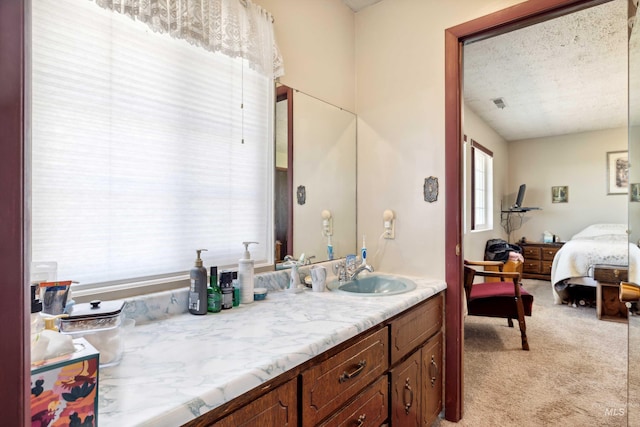 bathroom with a textured ceiling and vanity