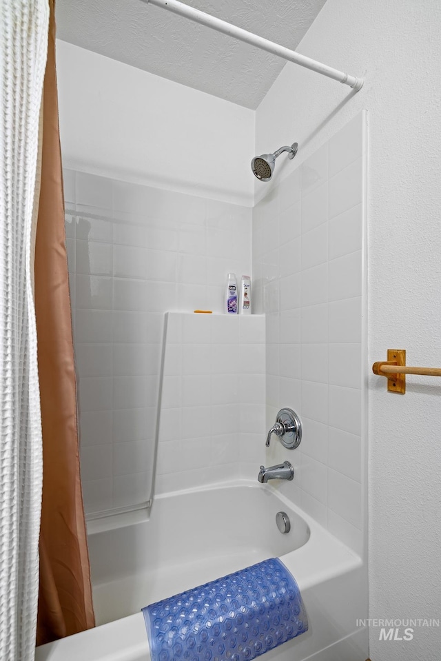 bathroom featuring a textured ceiling and shower / bath combo