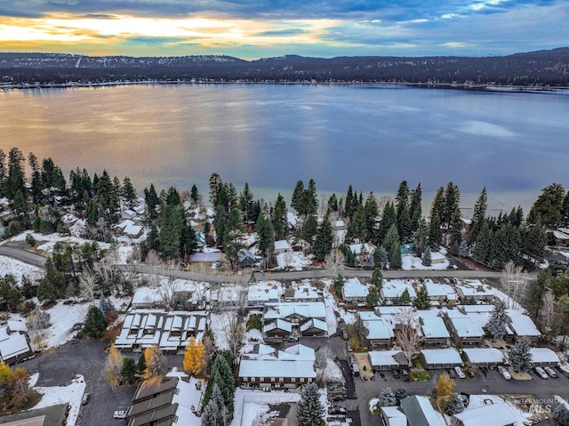 aerial view at dusk featuring a water view