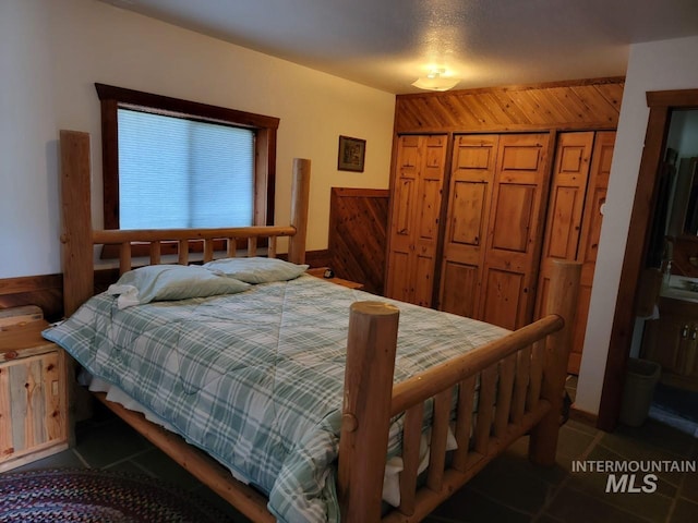 bedroom featuring a closet and dark tile floors