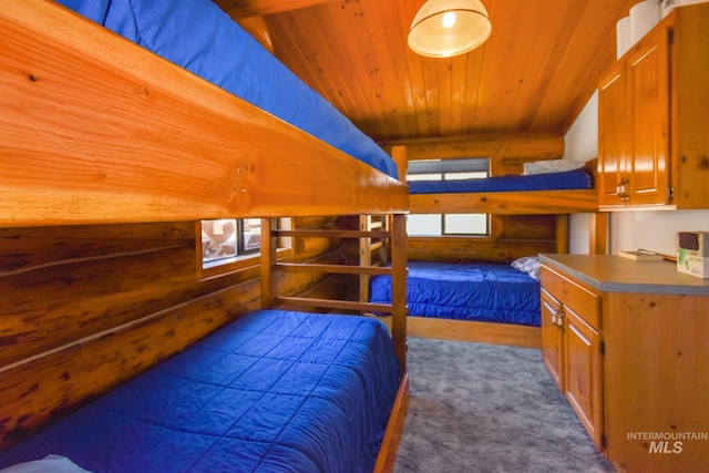 bedroom with multiple windows, wooden ceiling, dark colored carpet, and lofted ceiling