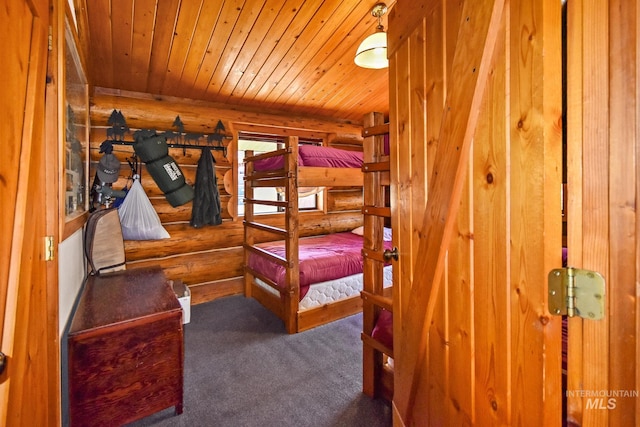 carpeted bedroom featuring log walls and wooden ceiling